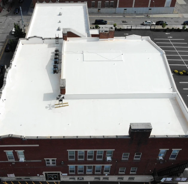 Aerial view of a white flat commercial roof.