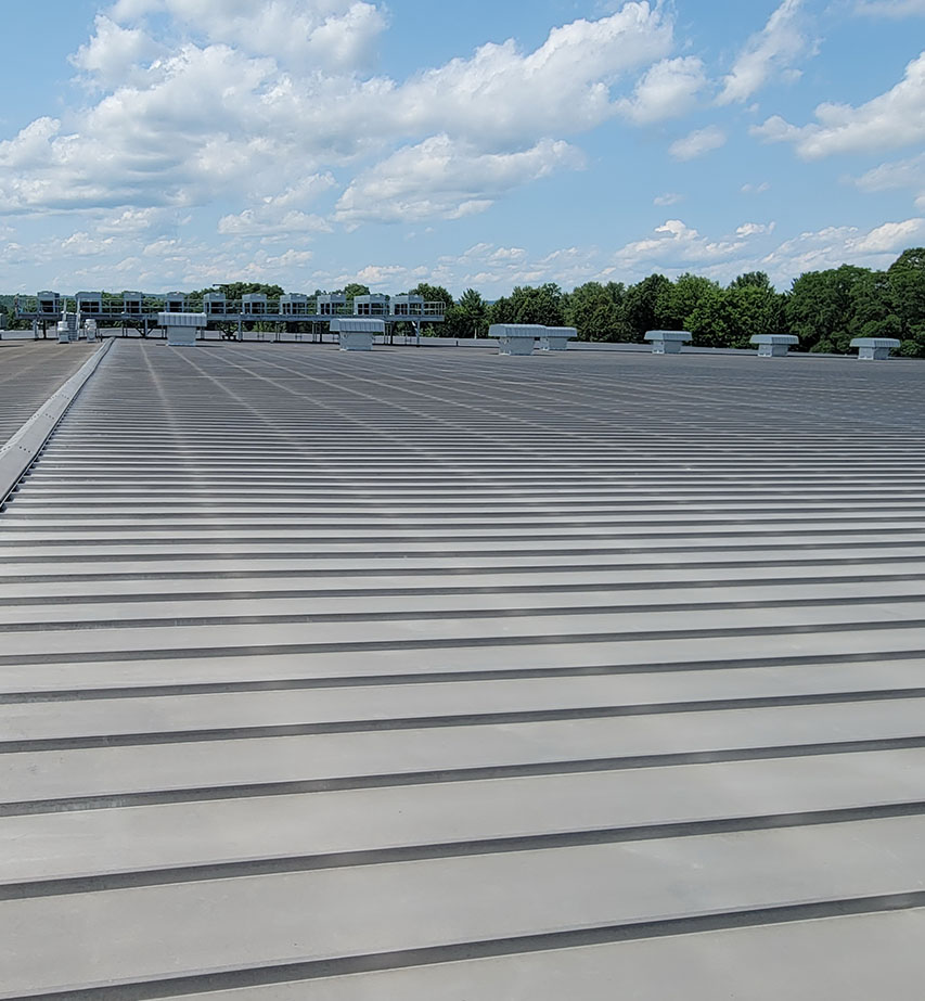 A rooftop view of a commercial metal roof in Worchester, MA