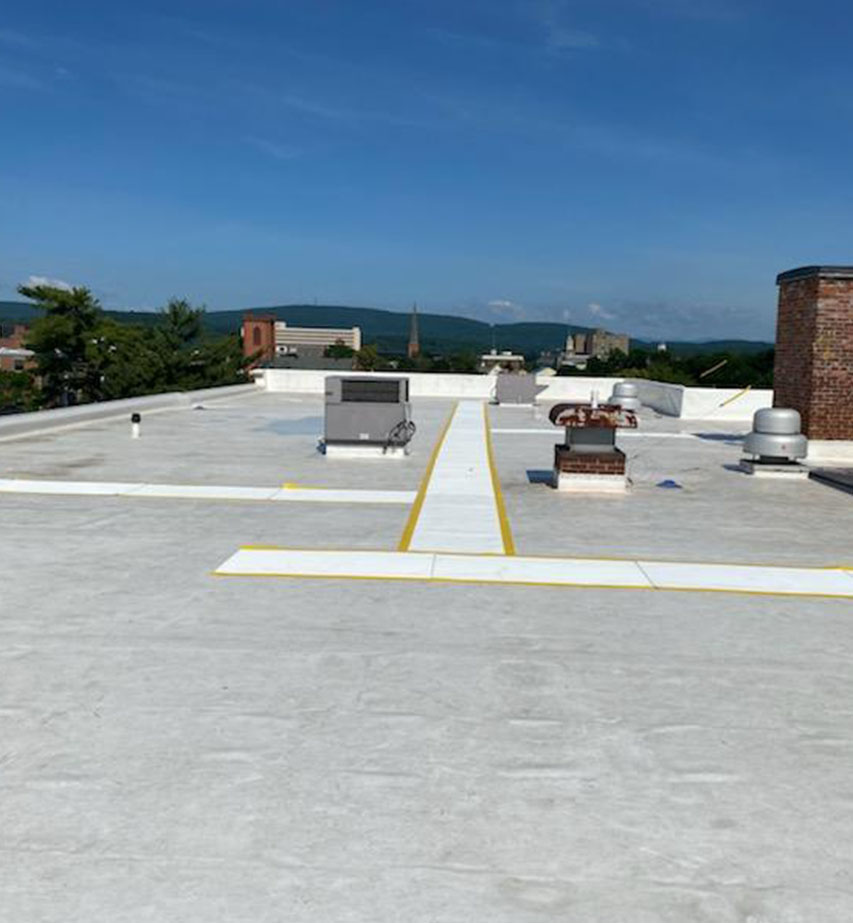 A rooftop view of a new flat commercial roof installation in Poughkeepsie, NY.
