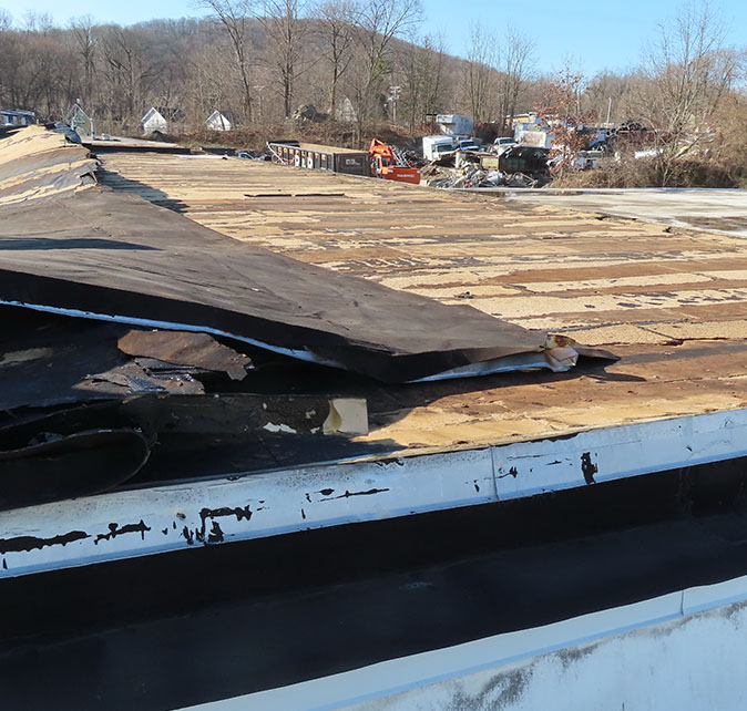 A damaged commercial roof in Newburgh, NY.