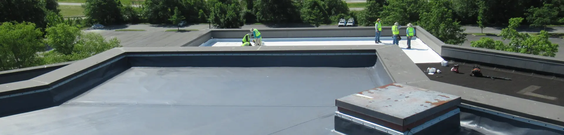 A Vanguard Roofing crew installing a flat commercial roof.