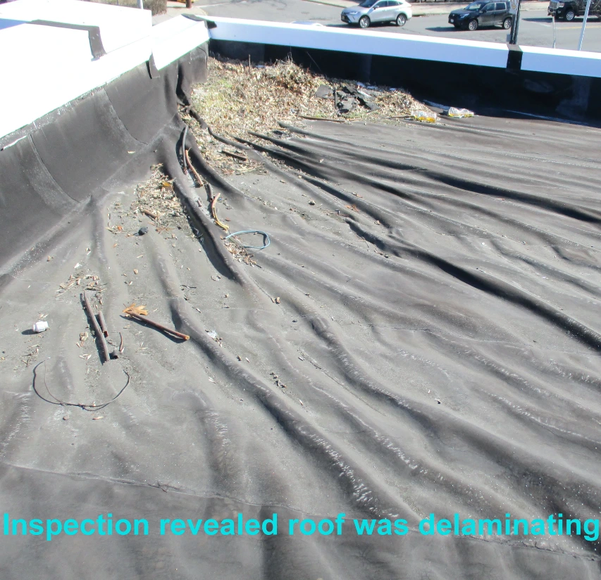 A delaminated commercial roof in Hartford, CT before repair by Vanguard Roofing.