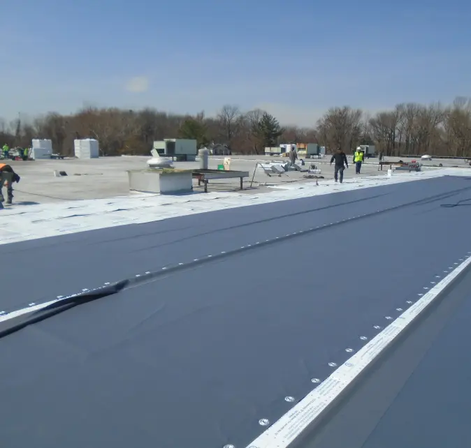 A commercial flat roof installation being performed by Vanguard Roofing