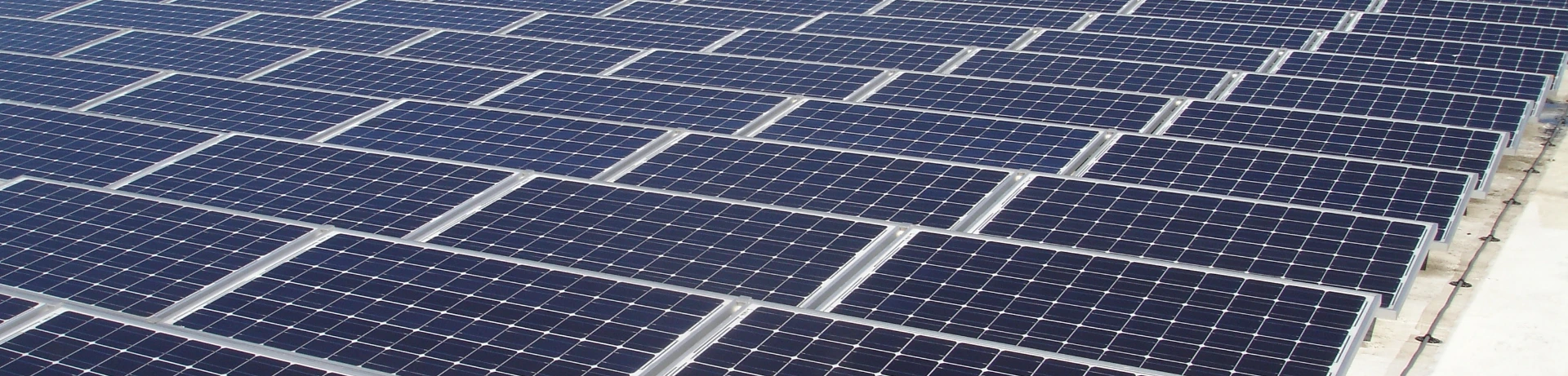An array of solar panels on a commercial roof.