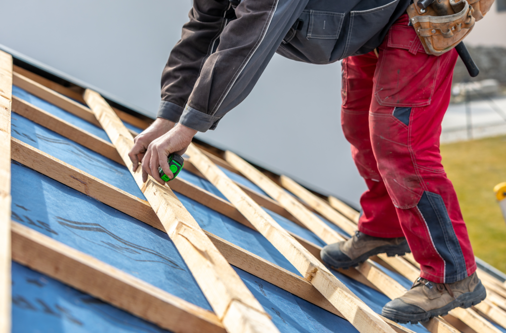 Roofer doing measurements during a roof replacement