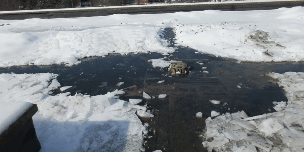 Ice dam formation on residential roof with standing water and snow accumulation showing potential winter storm damage showing why you need a commercial roof preventative maintenance checklist