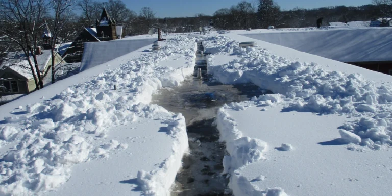 a path through heavy snow on a commercial flat roof.