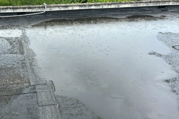 Ponding water causing damage to a commercial flat roof