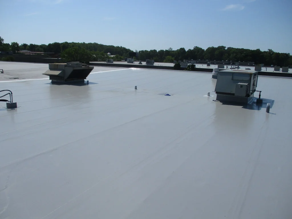 New commercial flat roof installation featuring a white TPO roofing system on a low-slope commercial building.