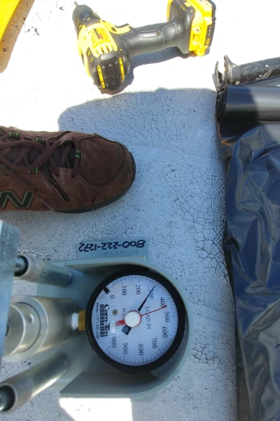 Vanguard Roofing technician performing a roof pull test on a commercial roof